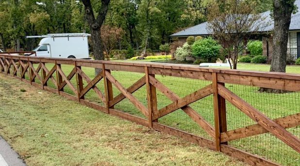 Stained crossbuck ranch fence installed by ProGuard Fencing